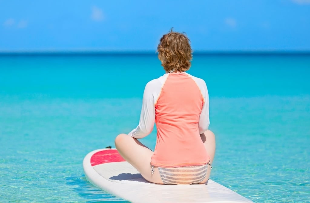 Woman on a paddle board wearing rashguard